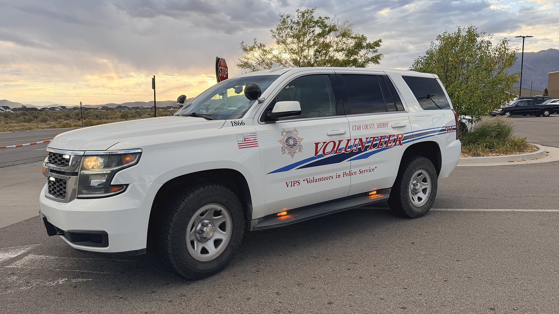 EMVIPS volunteer Tahoe marked Utah County Sheriff Volunteer, front view at sunset.
